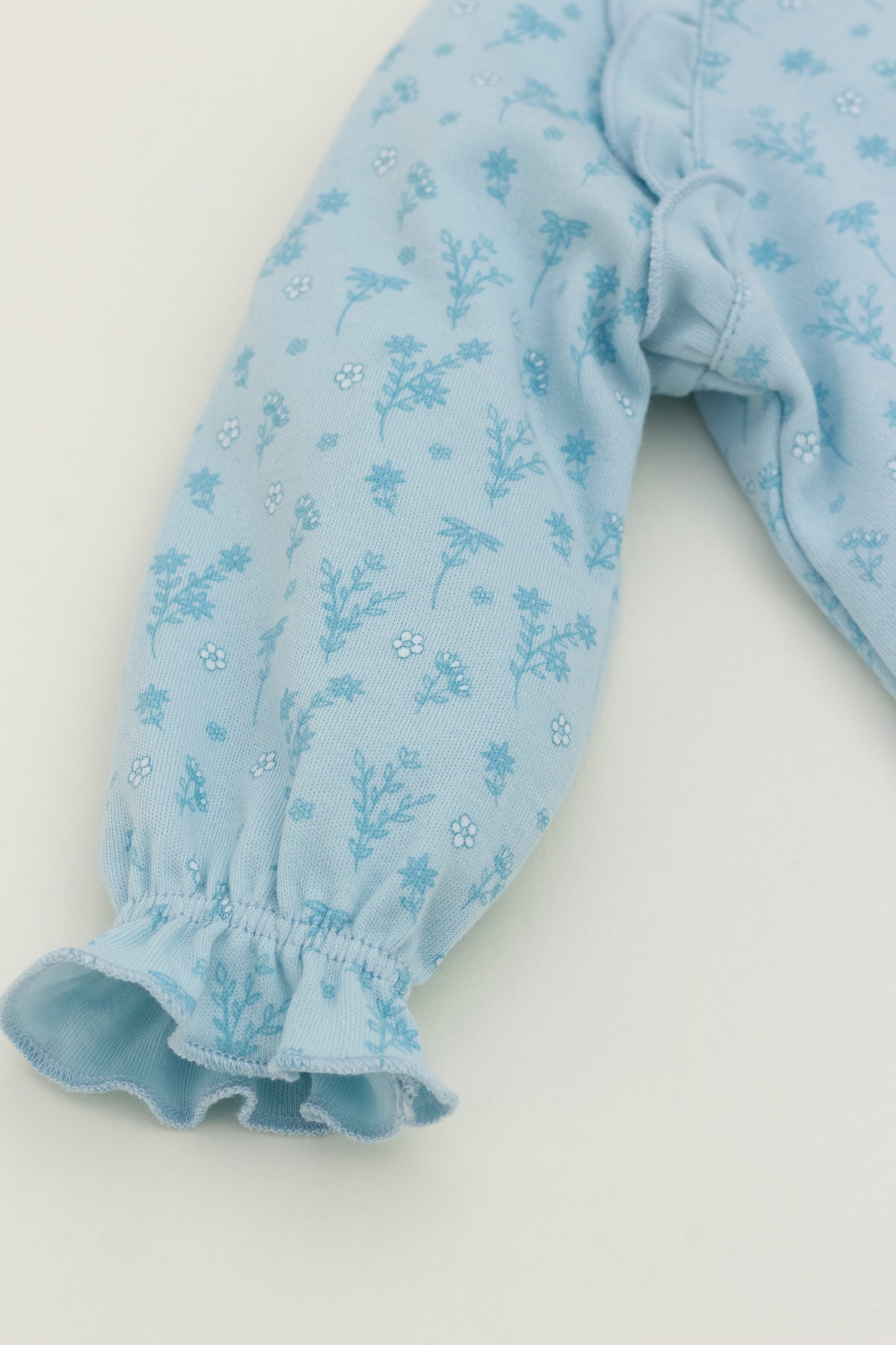 Light blue long sleeve romper with flower print