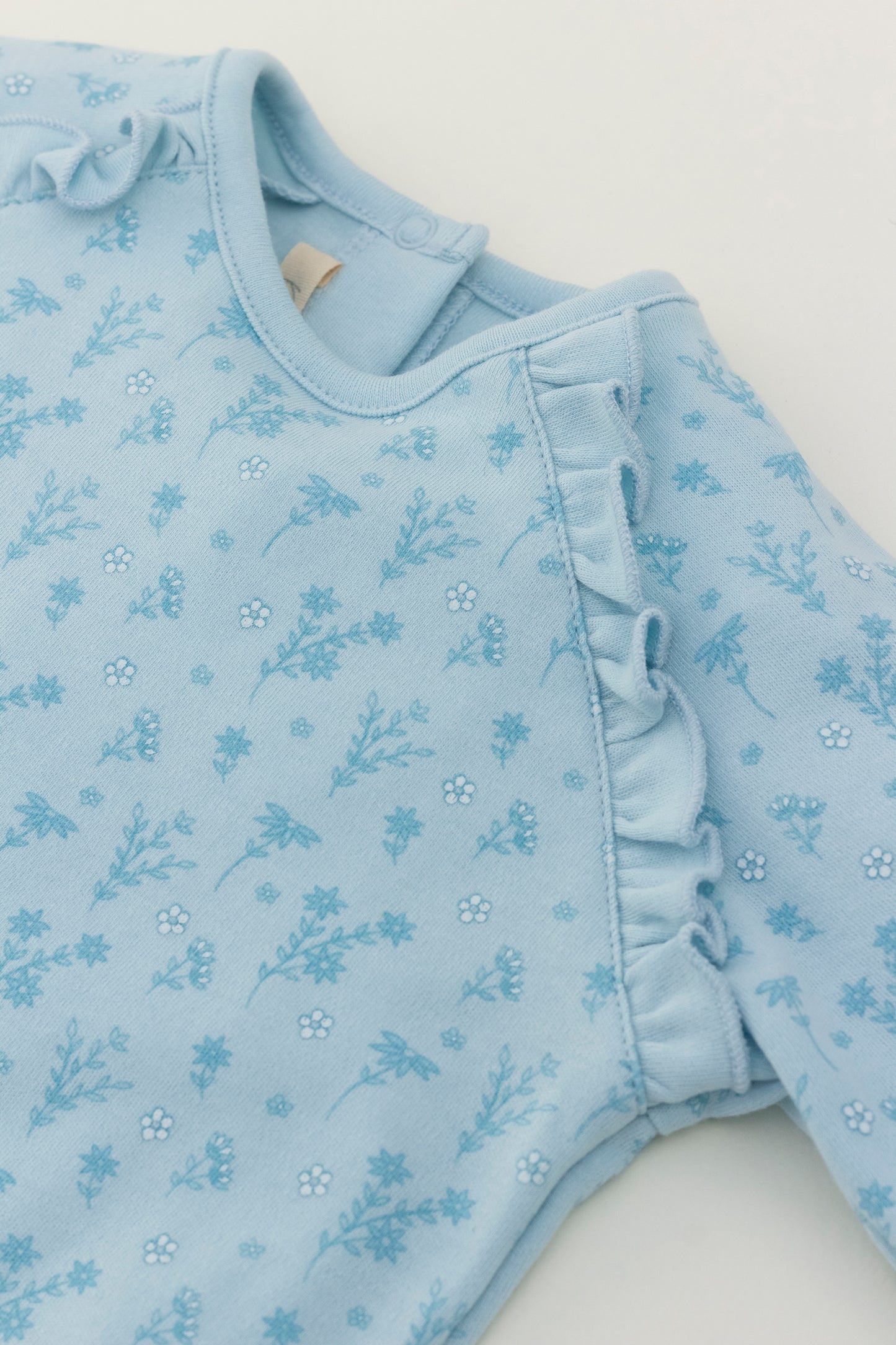 Light blue long sleeve romper with flower print