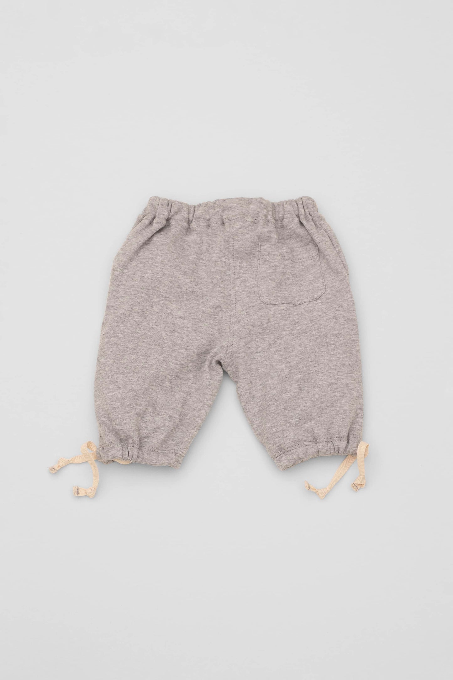 Grey organic pima cotton bermuda shorts with elasticized waist and fake pockets. Back view