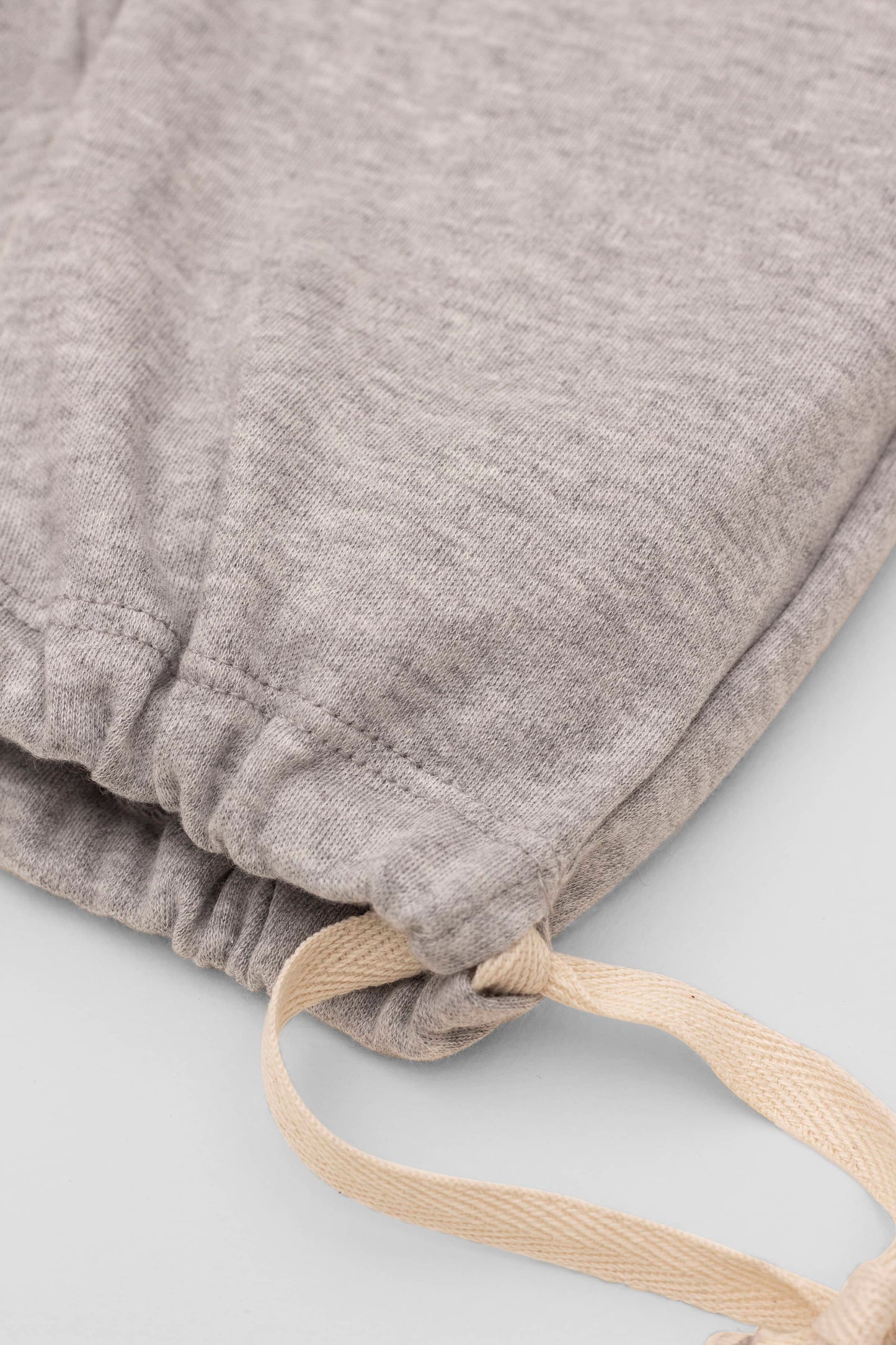 Grey organic pima cotton bermuda shorts with elasticized waist and fake pockets. Leg detail