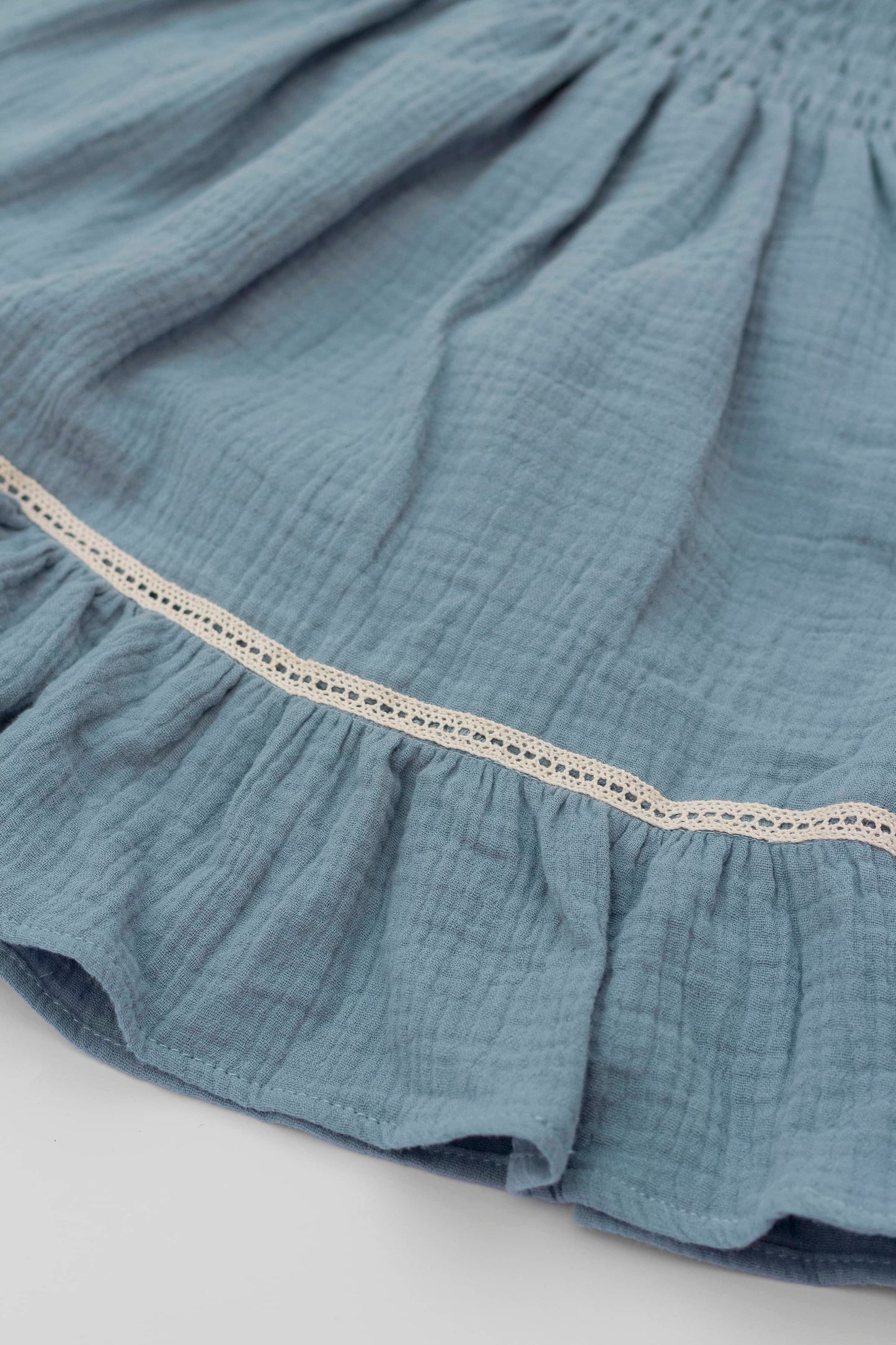 Blue organic cotton muslin dress with lace for baby girls skirt detail