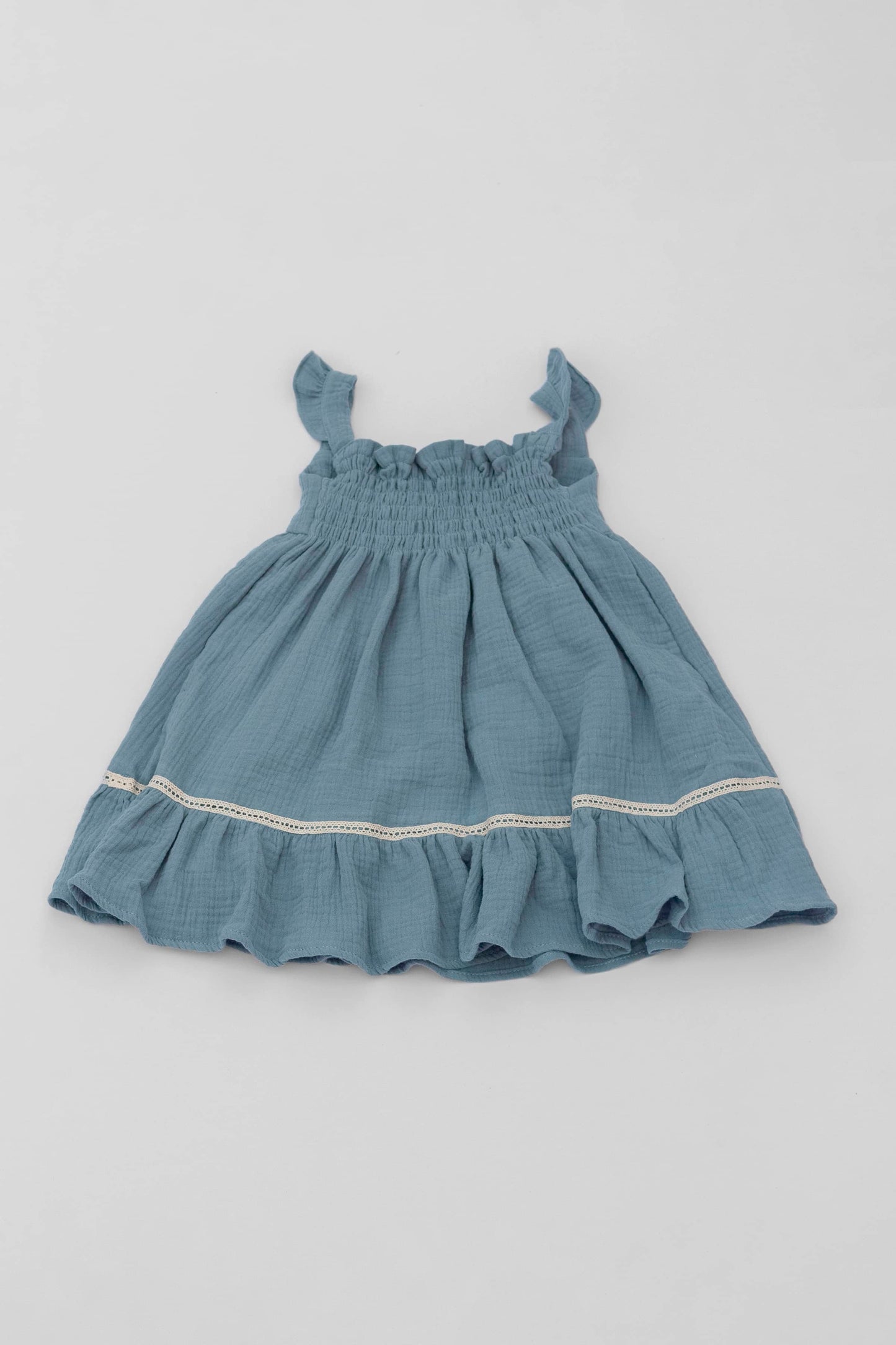 Blue organic cotton muslin dress with lace for baby girls back view