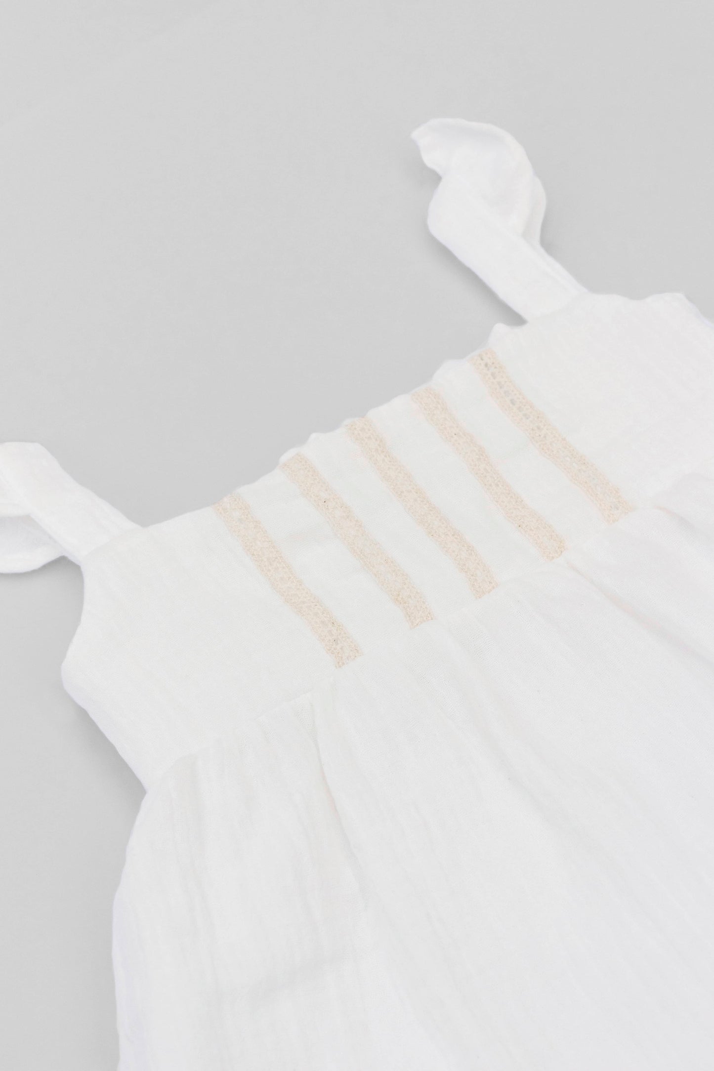 White organic cotton muslin dress with lace for baby girls front detail