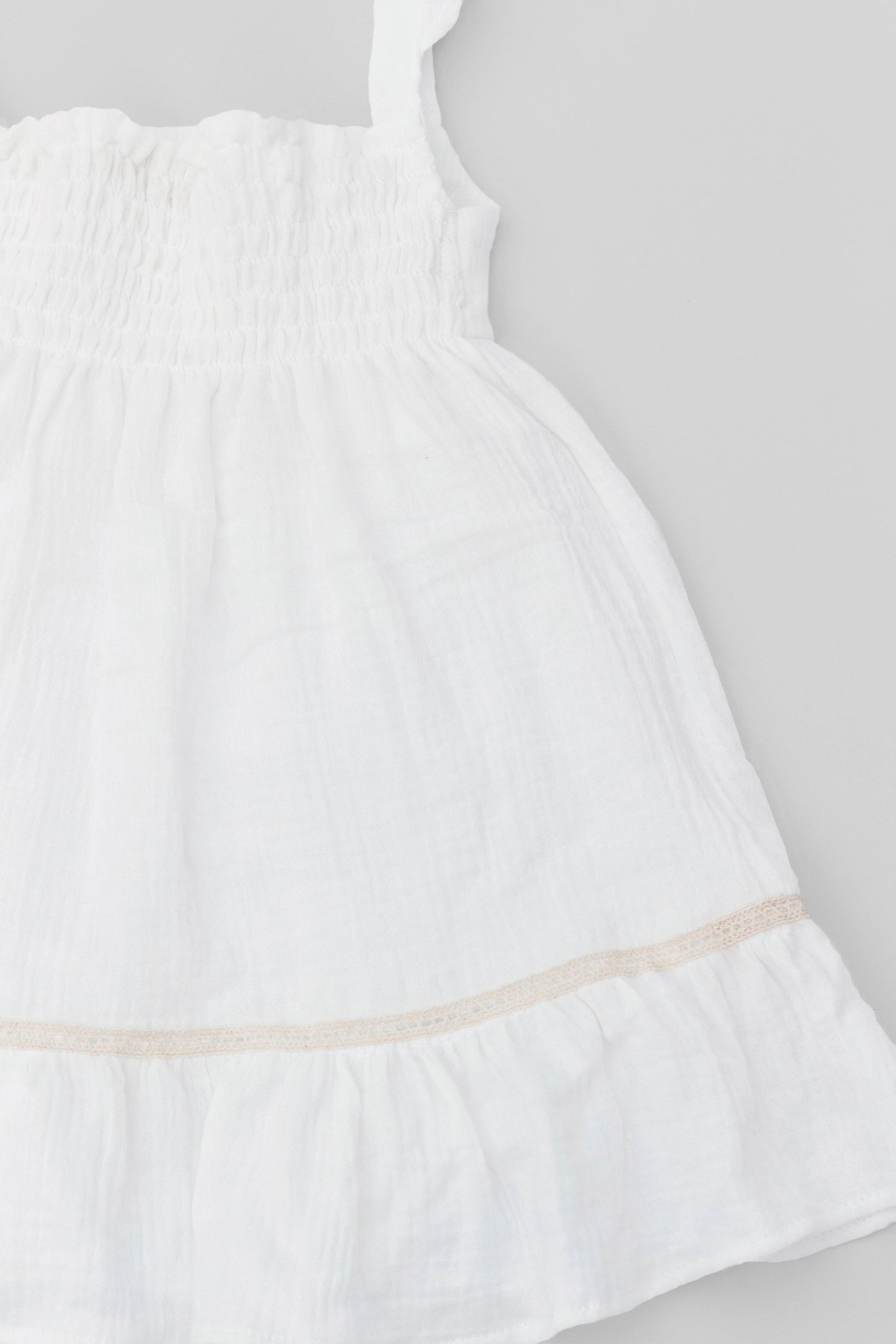 White organic cotton muslin dress with lace for baby girls back detail