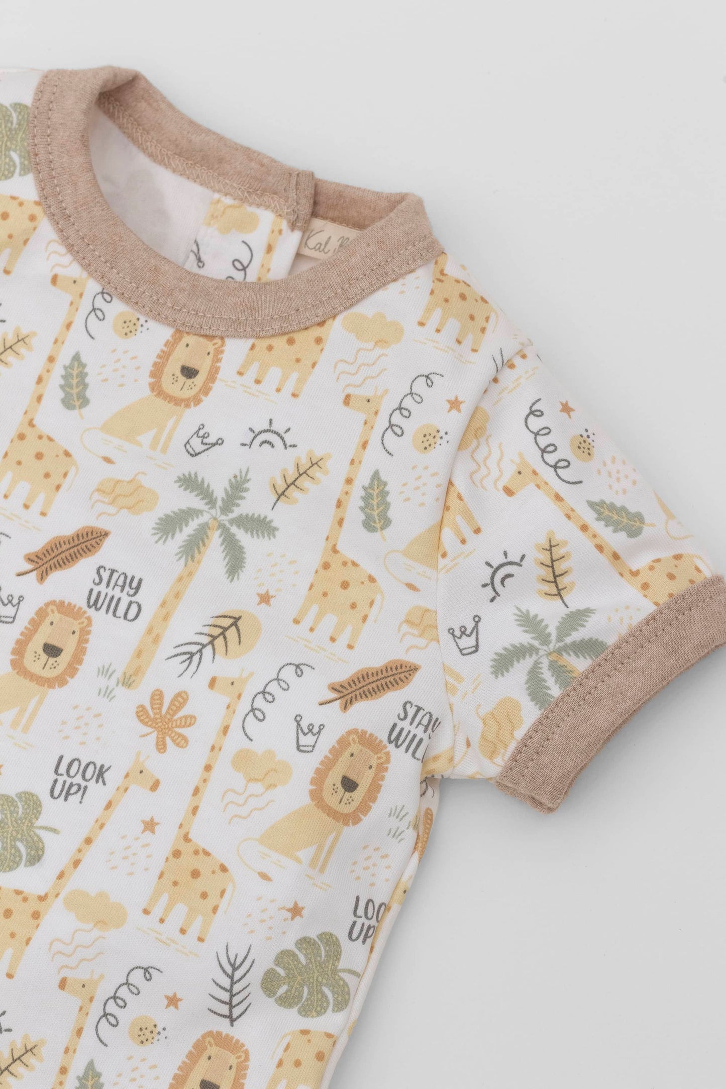 Organic pima cotton baby bodysuit. Safari printing and contrast sand piping. Neckline detail