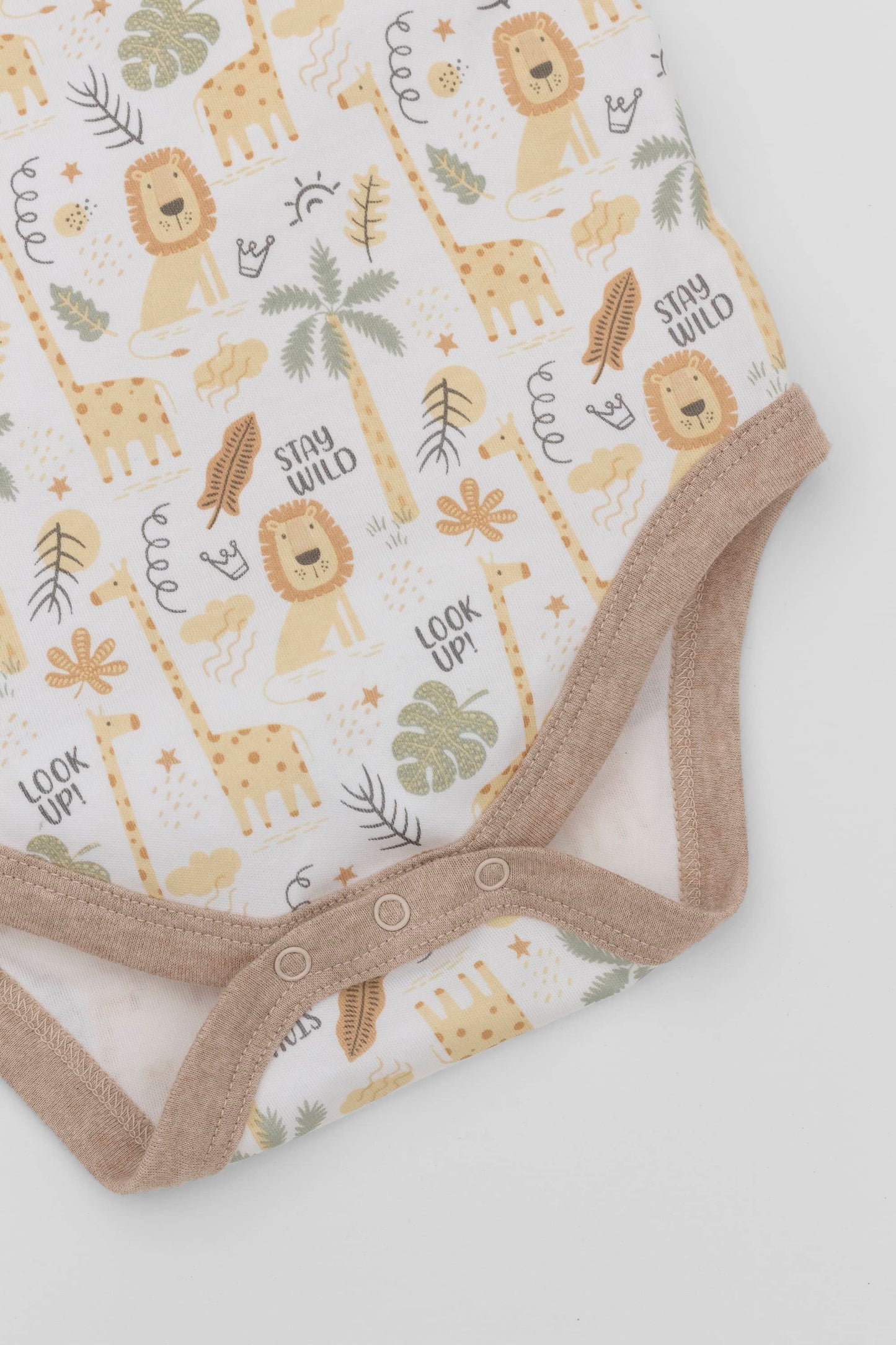 Organic pima cotton baby bodysuit. Safari printing and contrast sand piping. Inseam detail.