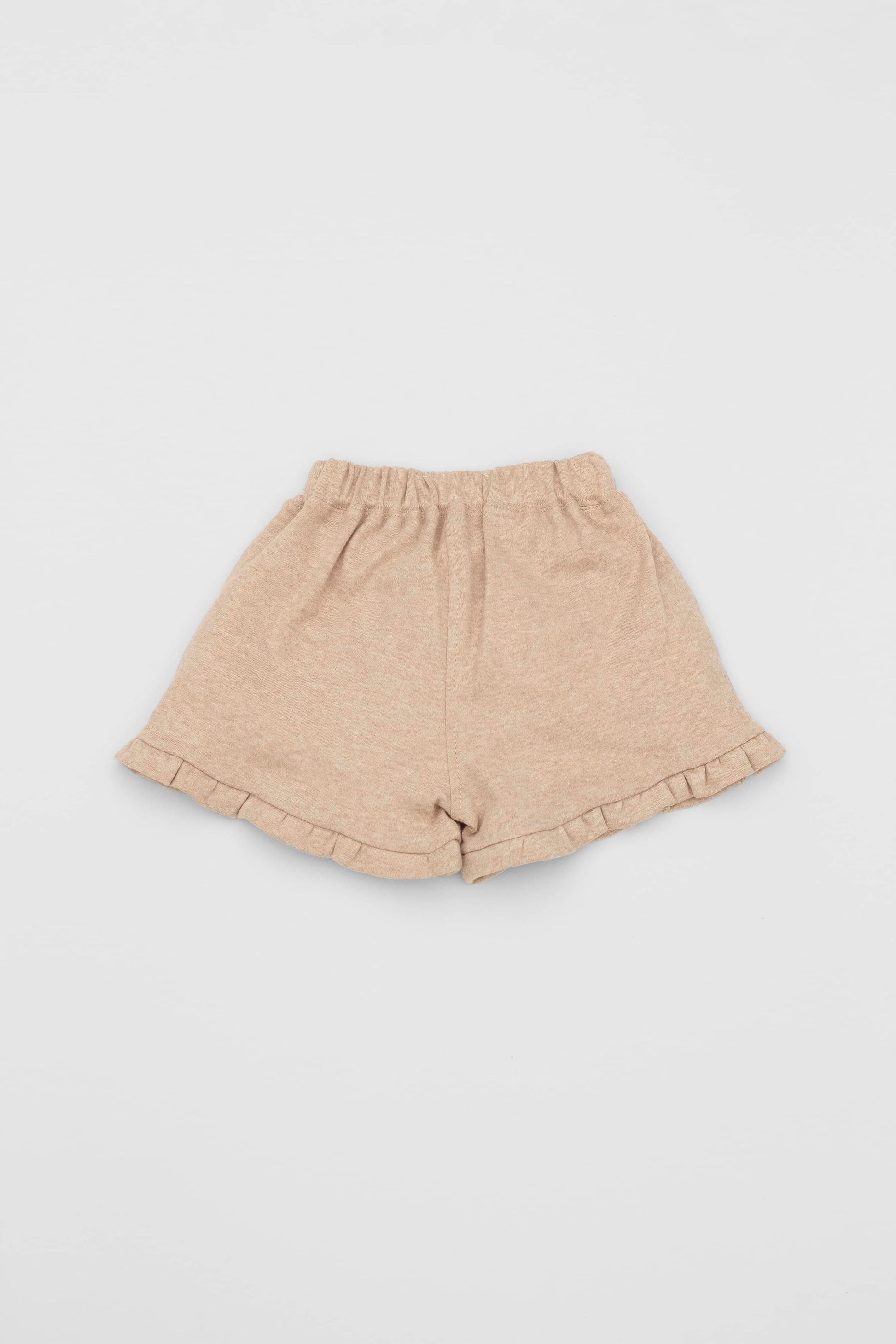 Organic pima cotton shorts with ruffle hem, elasticized waist and fake pockets. Sand. Back view