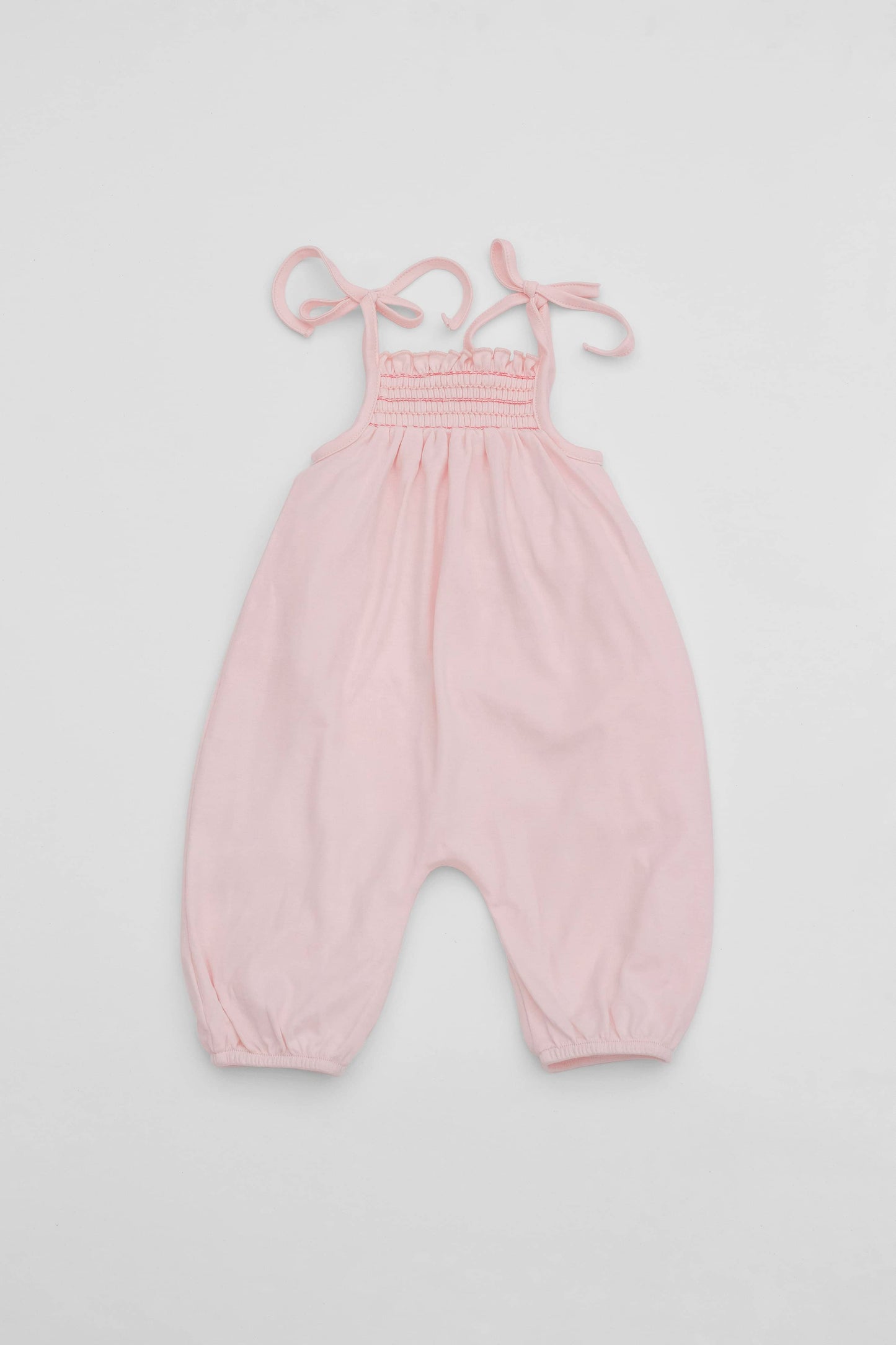 Smocked pink organic romper with straps and embroidery - back
