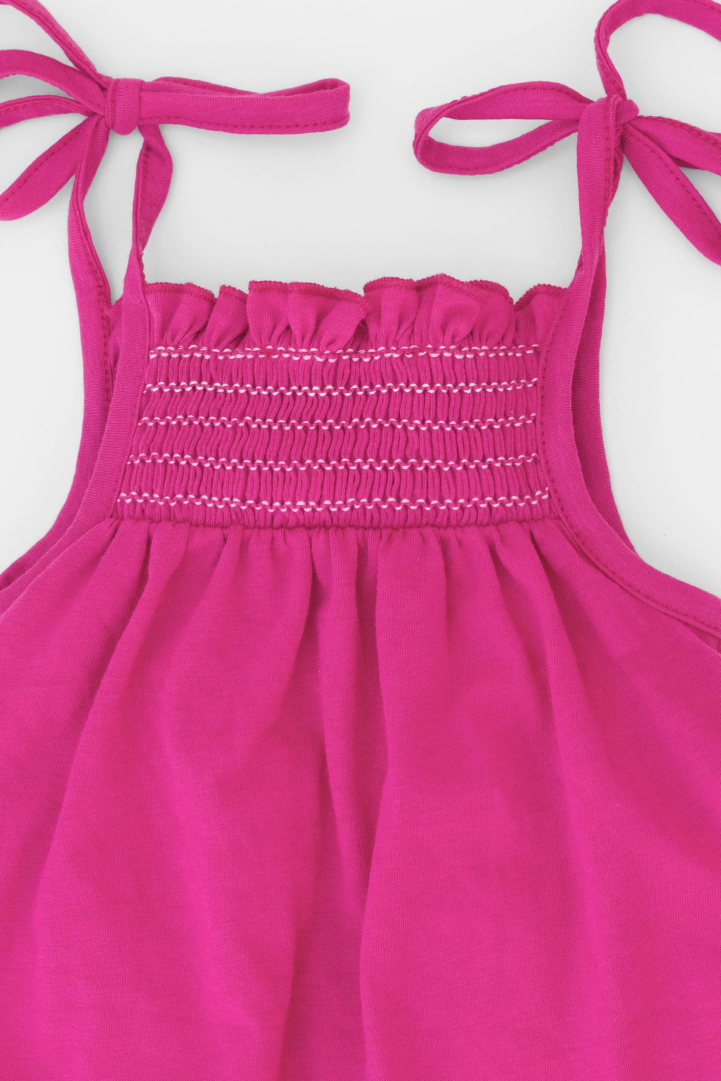 Smocked very berry organic romper with straps and embroidery. Back view detail