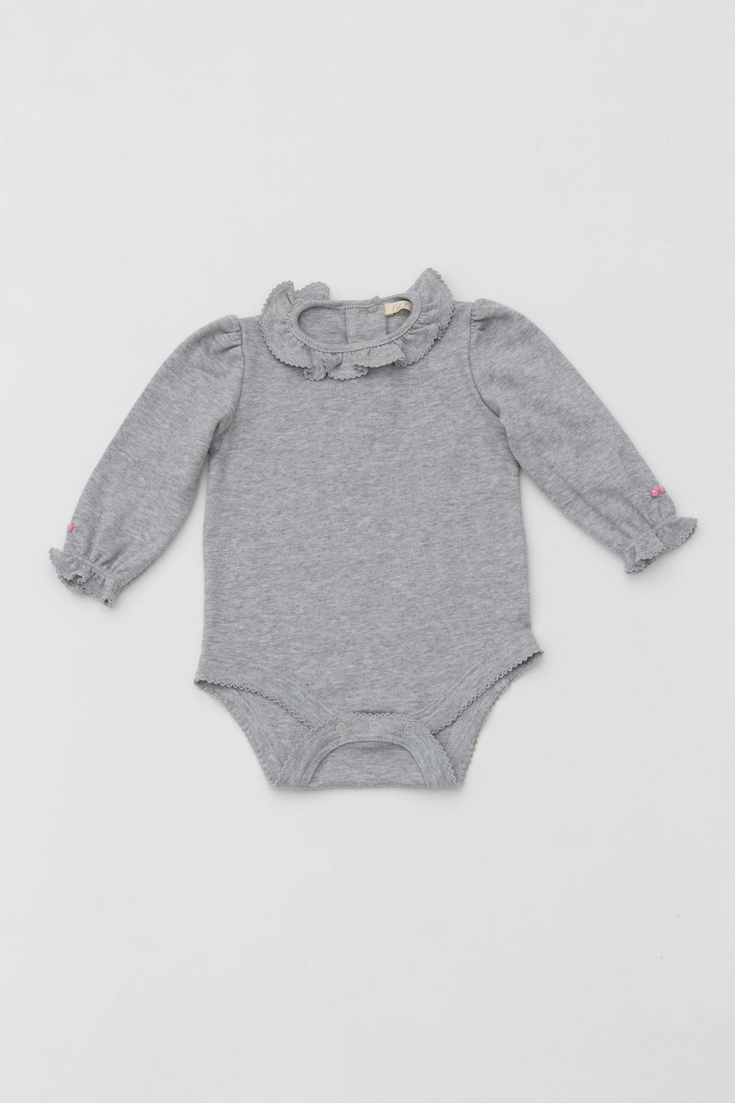 Bodysuit with ruffle collar and and long puff sleeves. Floral embroidery on sleeves. Snaps inseam. Back button closure. Heather grey color. Front view