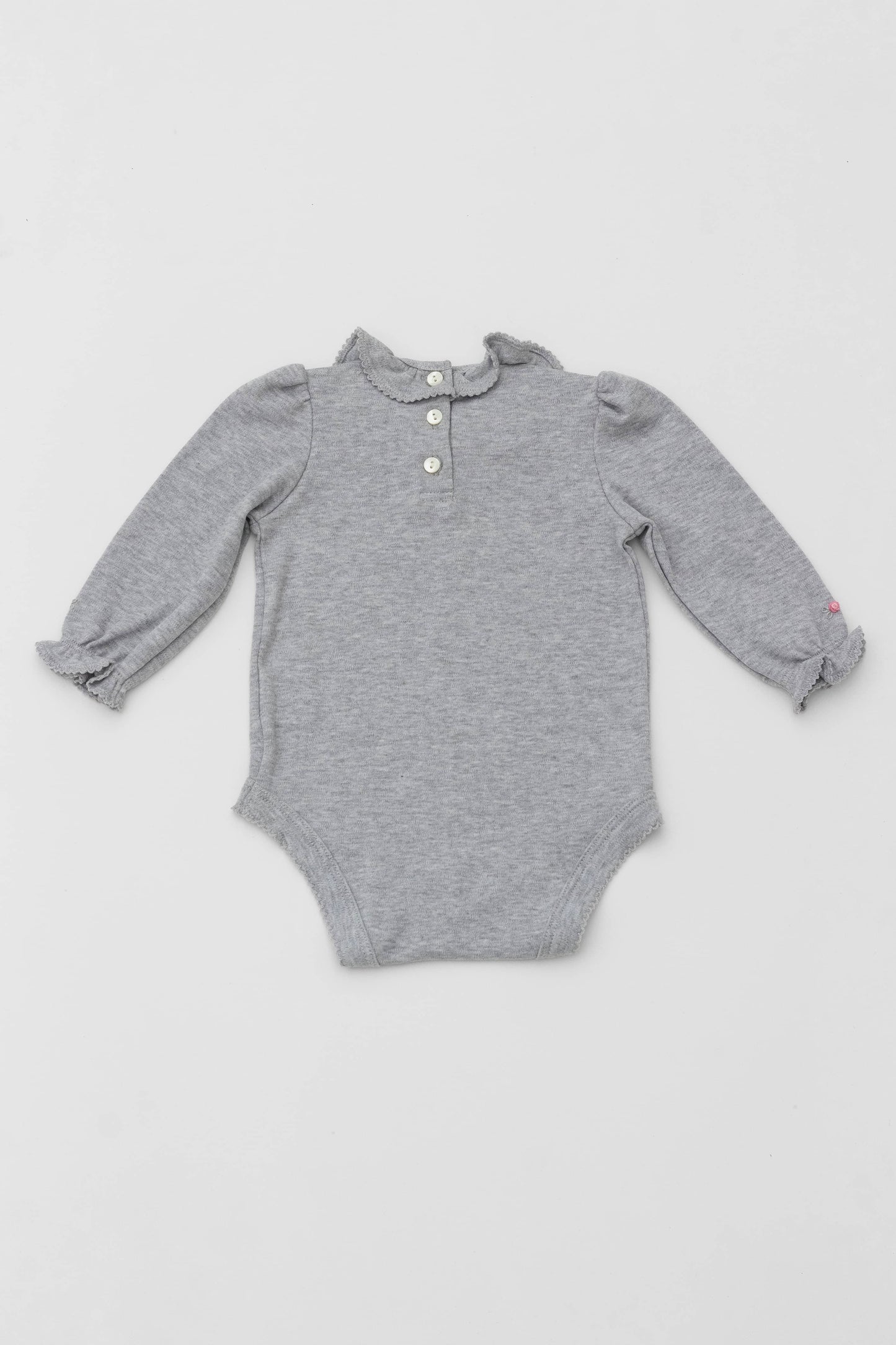Bodysuit with ruffle collar and and long puff sleeves. Floral embroidery on sleeves. Snaps inseam. Back button closure. Heather grey color. Back view
