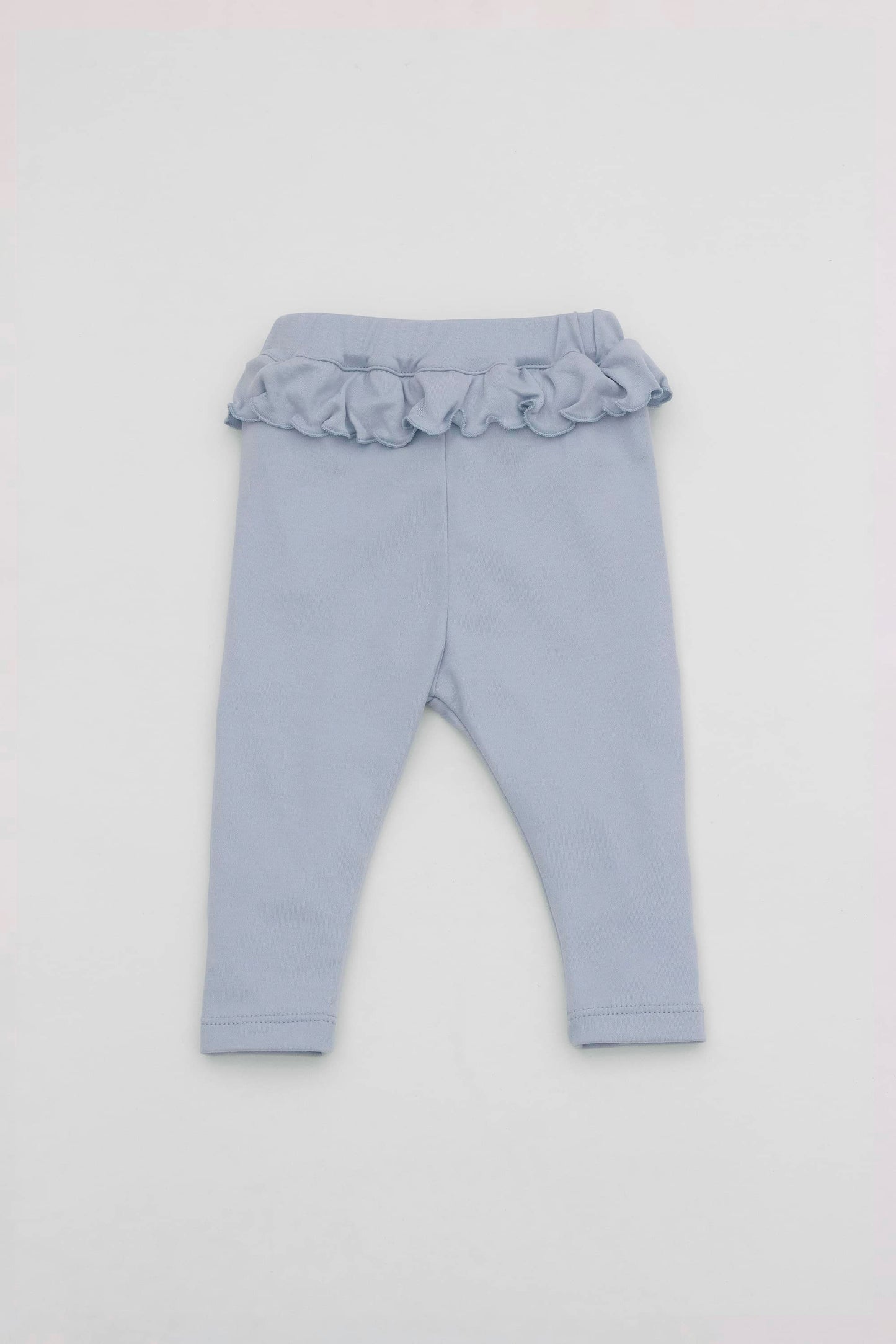 Baby blue leggings with ruffled accent on the waistband. Back