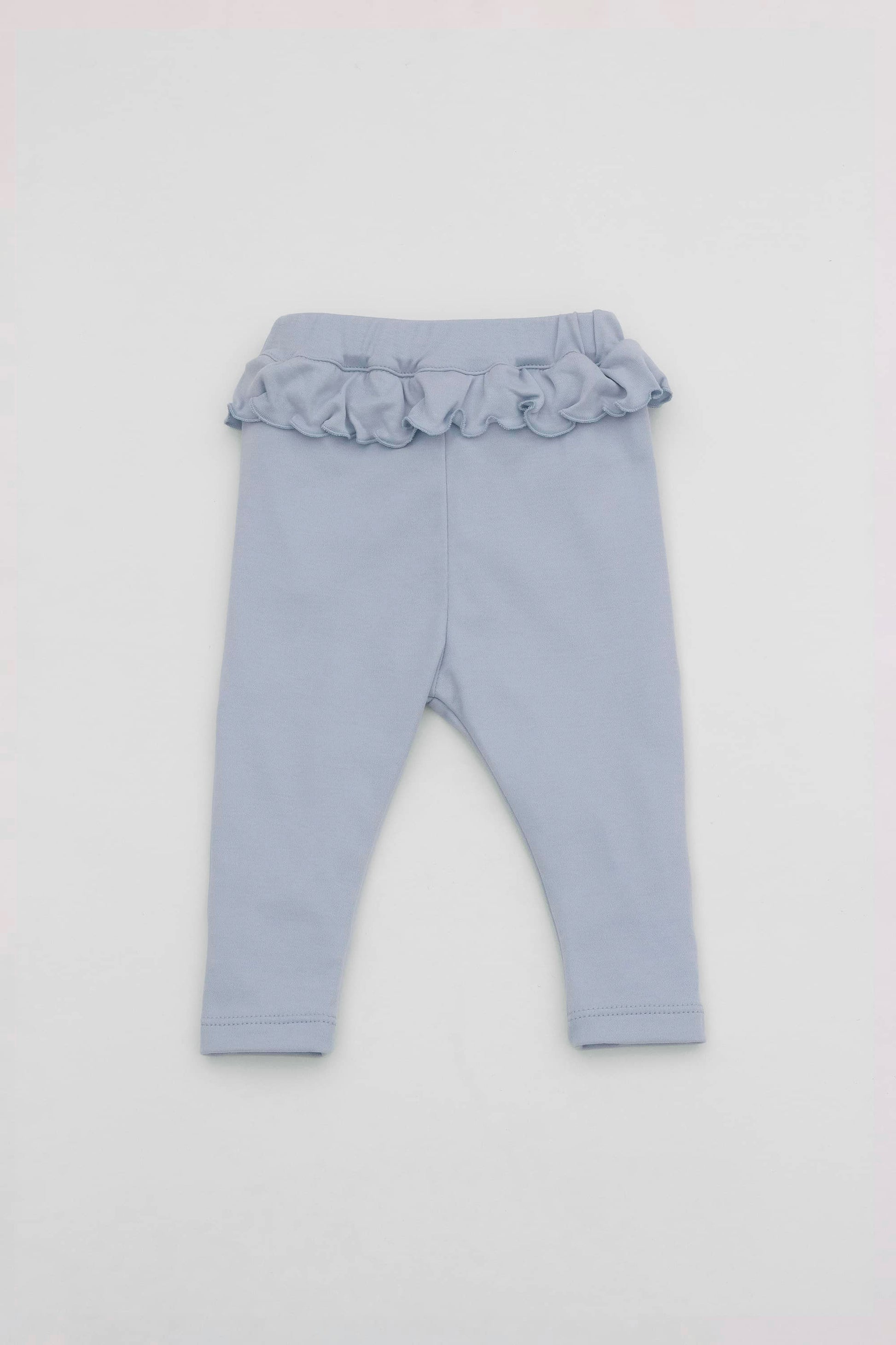 Baby blue leggings with ruffled accent on the waistband. Back