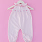 Pink romper with hand embroidered flowers