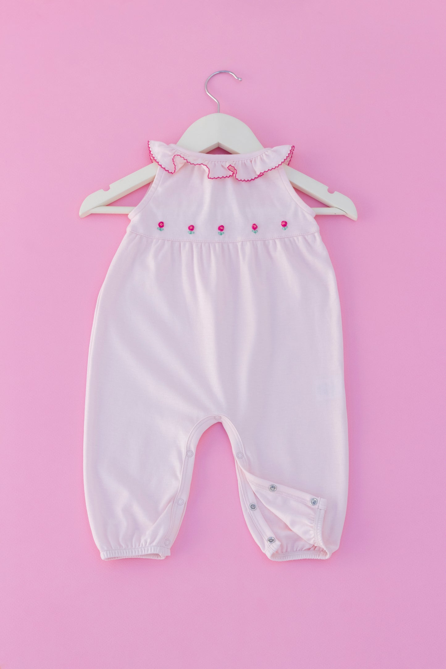 Pink romper with hand embroidered flowers