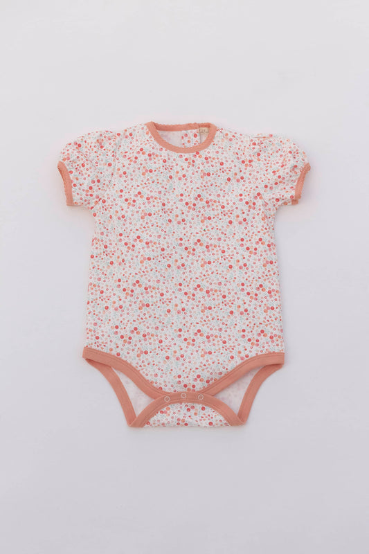 Organic pima cotton puff sleeve bodysuit. Floral printing and contrast sand piping with scalloped trimed. Front view