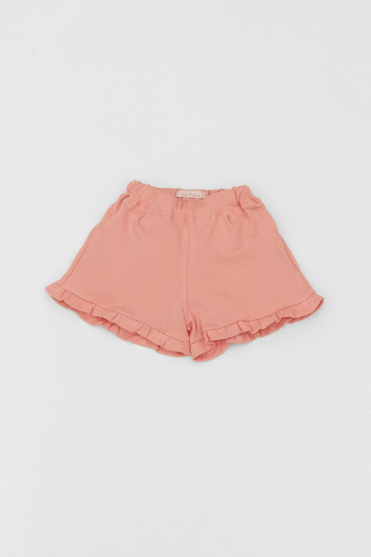 Organic pima cotton shorts with ruffle hem, elasticized waist and fake pockets. soft melon. Front view