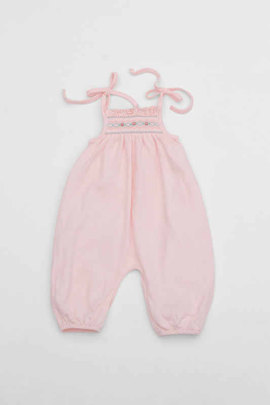 Smocked pink organic romper with straps and embroidery - front