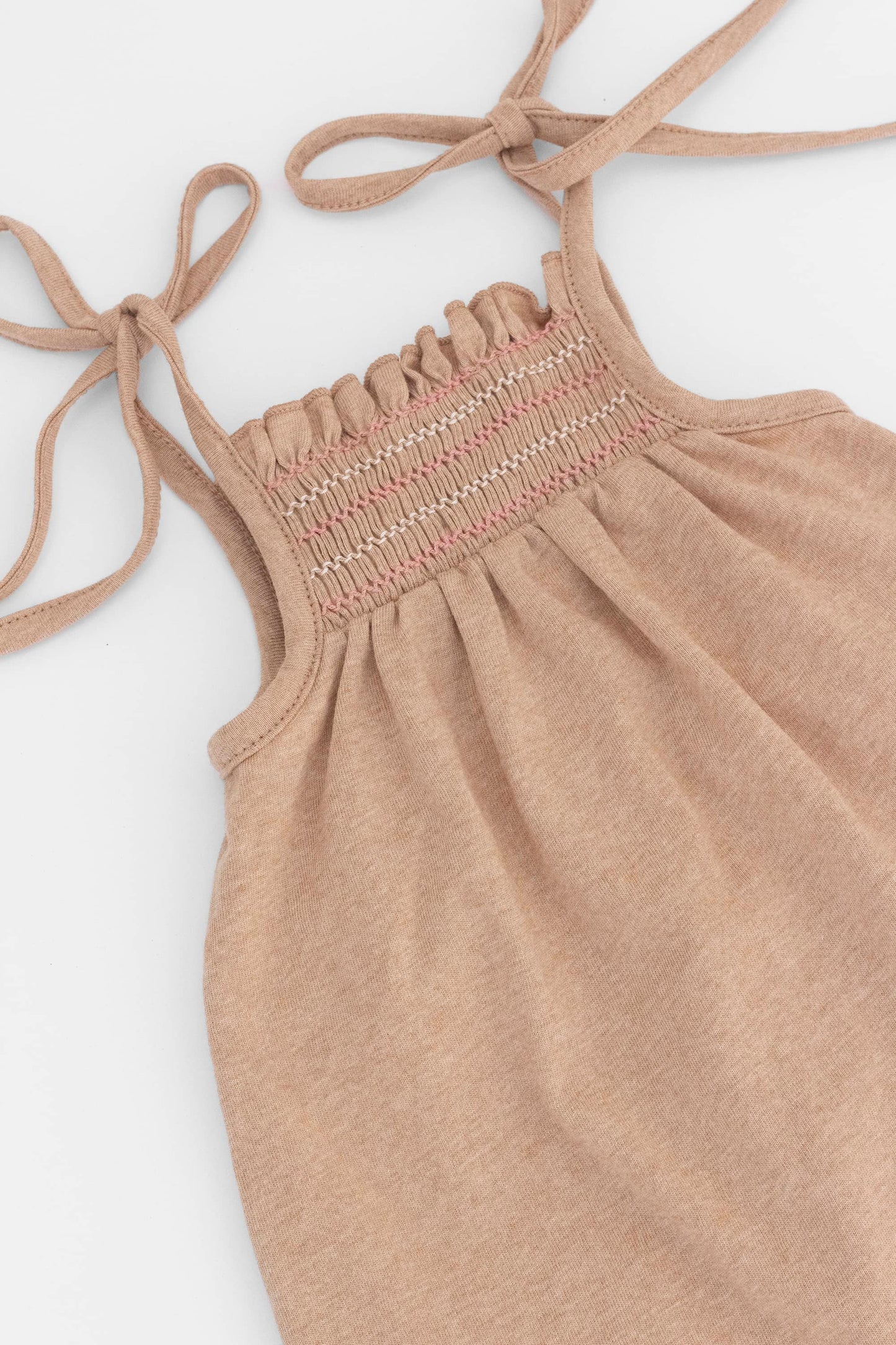 Smocked caramel organic romper with straps and embroidery