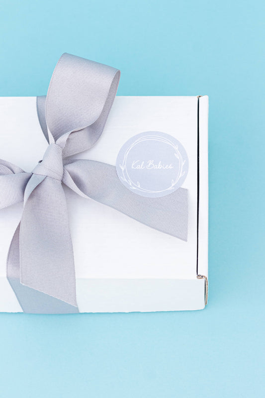 White eco-friendly gift box and tissue paper. Grey sitckers. Fully compostable. Grey ribbon bow detail