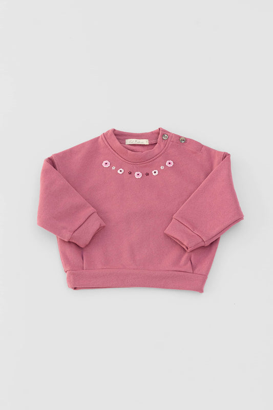 Long sleeve fleece sweatshirt with buttons at shoulder. Embroidery at front. Elderberry certified organic cotton. Front view